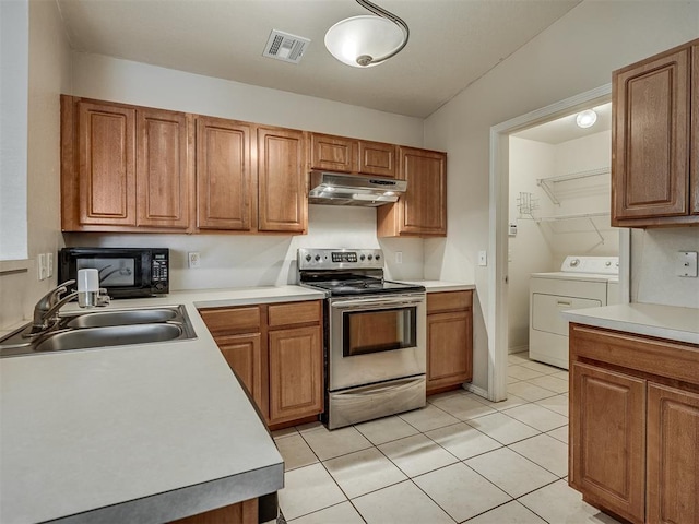 kitchen featuring washer and clothes dryer, light tile patterned flooring, electric stove, and sink