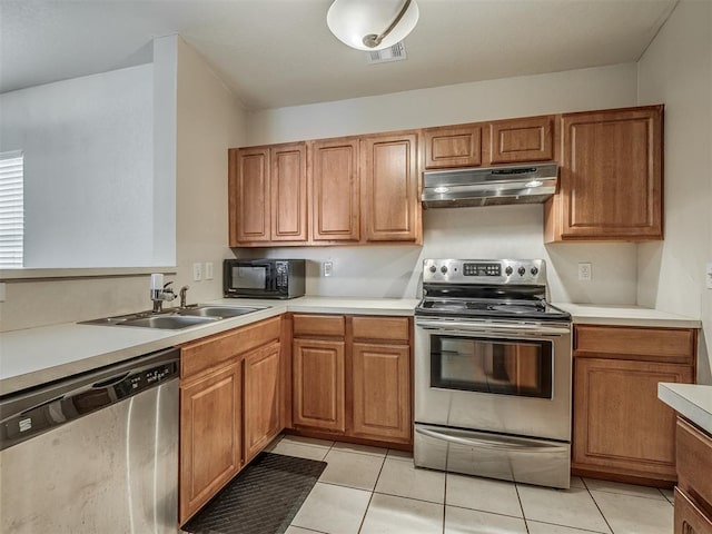 kitchen featuring light tile patterned flooring, sink, and stainless steel appliances