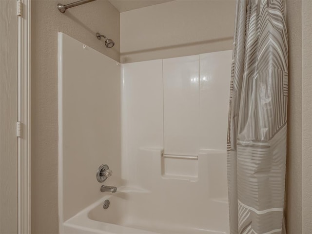 bathroom with shower / bath combo with shower curtain