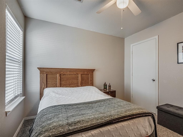 bedroom with carpet flooring, ceiling fan, and multiple windows