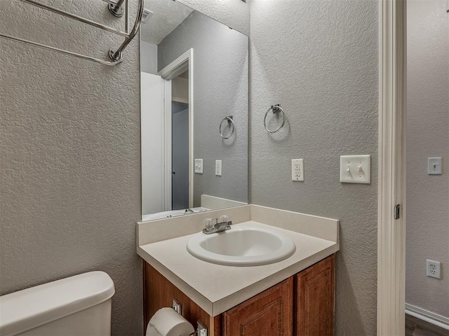 bathroom with vanity and toilet