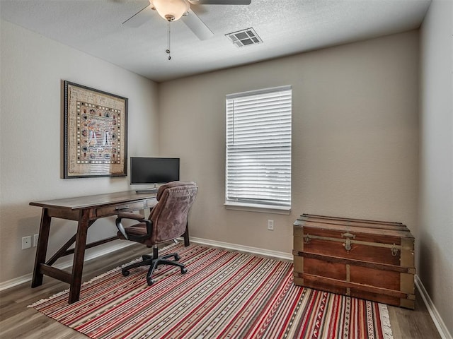 office space with ceiling fan, wood-type flooring, and a textured ceiling