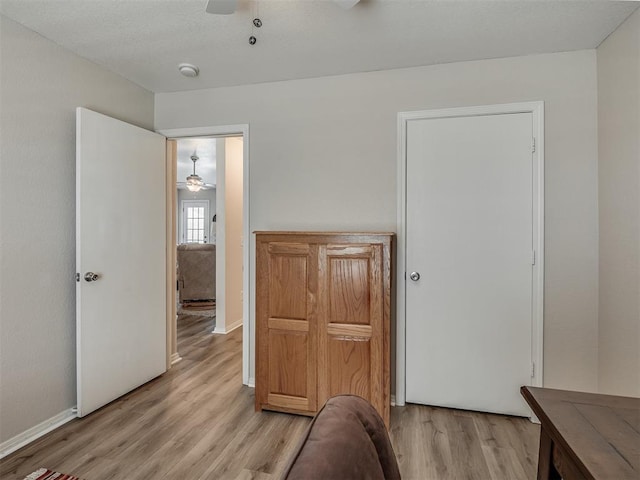 bedroom with light hardwood / wood-style flooring and ceiling fan