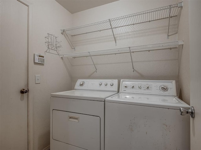 washroom with washing machine and dryer