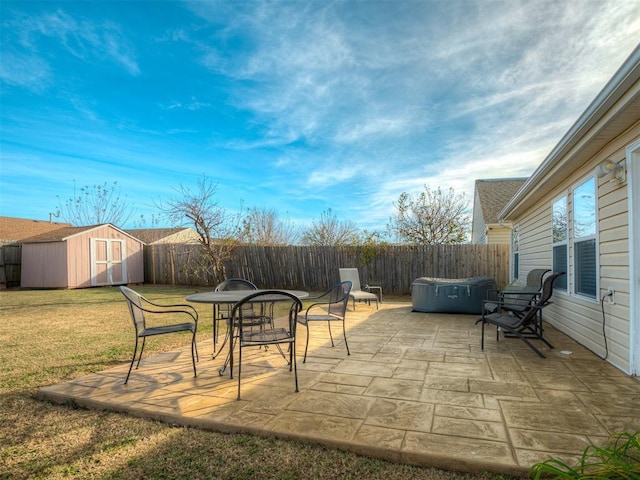 view of patio / terrace featuring a hot tub and a shed