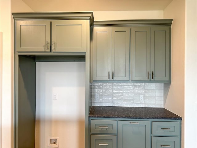 kitchen with dark stone counters and tasteful backsplash