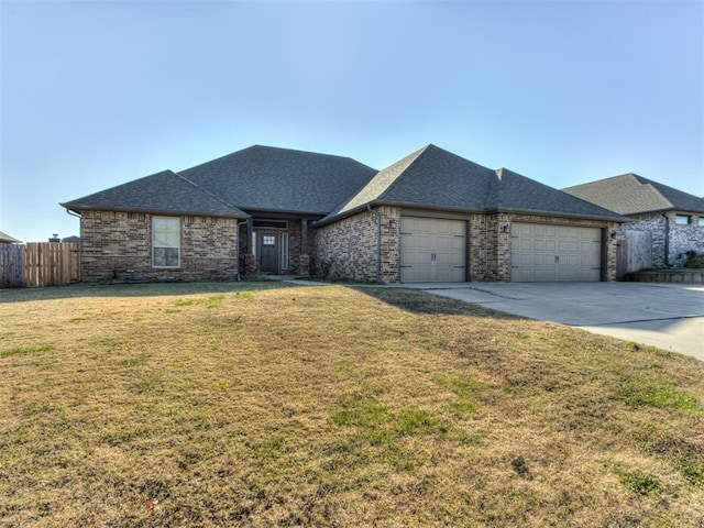 view of front facade with a garage and a front lawn