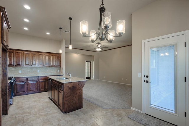 kitchen with light colored carpet, an island with sink, stainless steel appliances, and decorative light fixtures