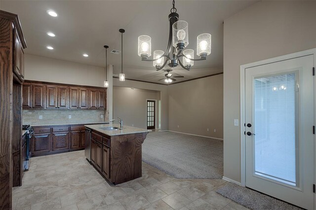 kitchen featuring sink, stainless steel appliances, an island with sink, decorative light fixtures, and ceiling fan with notable chandelier