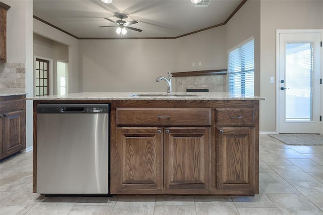 kitchen with an island with sink, stainless steel dishwasher, ornamental molding, and sink