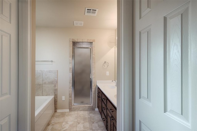 bathroom featuring tile patterned floors, vanity, and independent shower and bath