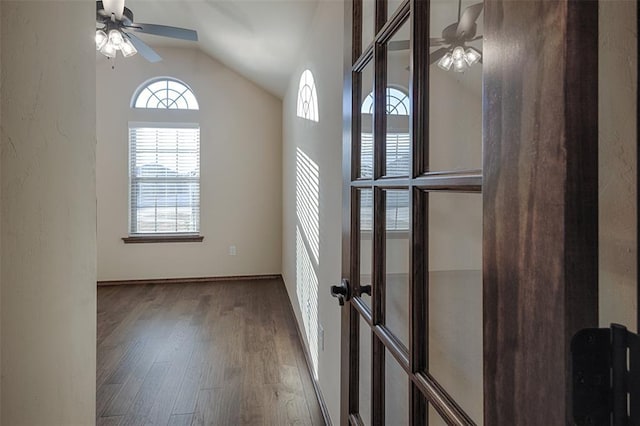 empty room featuring ceiling fan, french doors, wood-type flooring, and lofted ceiling