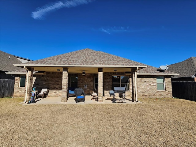 rear view of property featuring a yard, ceiling fan, and a patio area