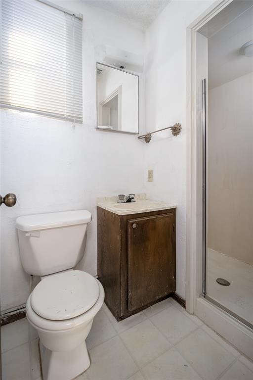 bathroom with vanity, toilet, and a shower with shower door