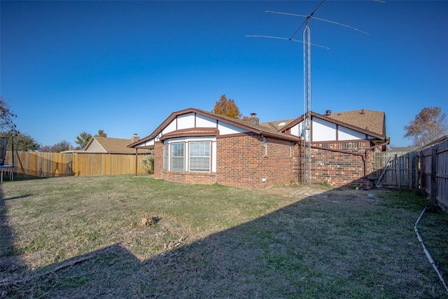 exterior space featuring a trampoline and a fenced backyard