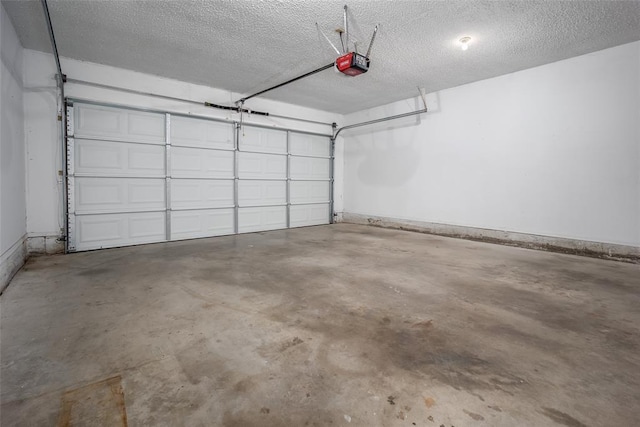 garage featuring baseboards and a garage door opener