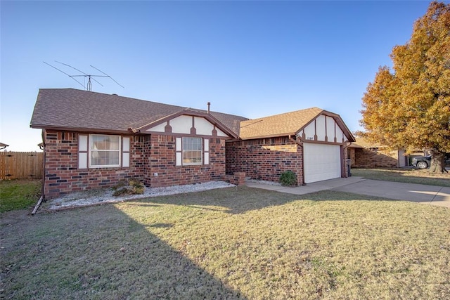 tudor home featuring brick siding, a front lawn, and fence