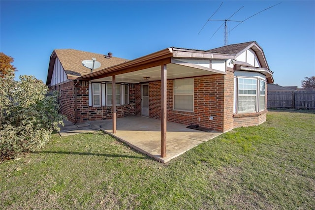 back of house featuring brick siding, a patio area, and fence