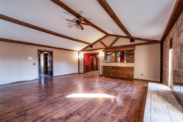 unfurnished living room featuring ceiling fan, lofted ceiling with beams, a fireplace, and wood-type flooring