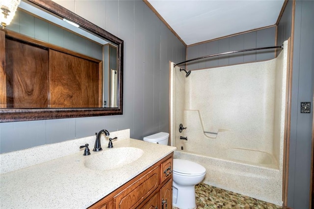 full bathroom featuring toilet, vanity, wood walls, and shower / bath combination