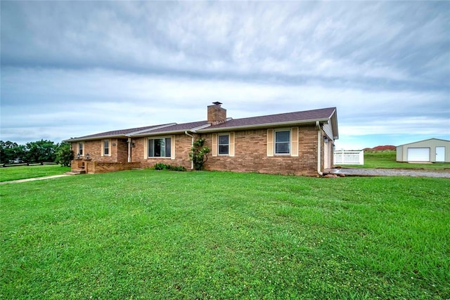 920173 S 3450th Rd, Chandler, OK 74834 - view of front of house featuring a chimney, a detached garage, brick siding, and a front yard