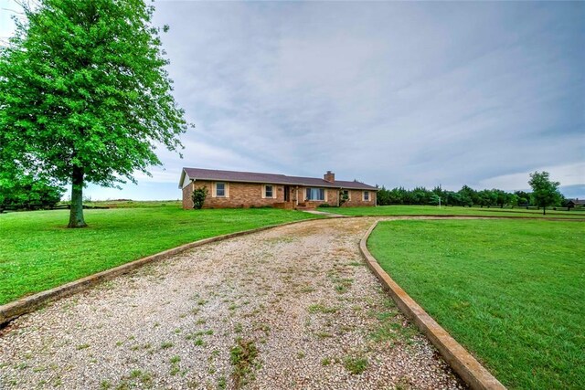 920173 S 3450th Rd, Chandler, OK 74834 - ranch-style home with driveway, a chimney, a front yard, and brick siding