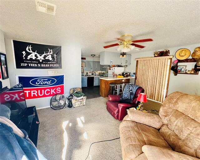 living room with carpet flooring, a textured ceiling, and ceiling fan