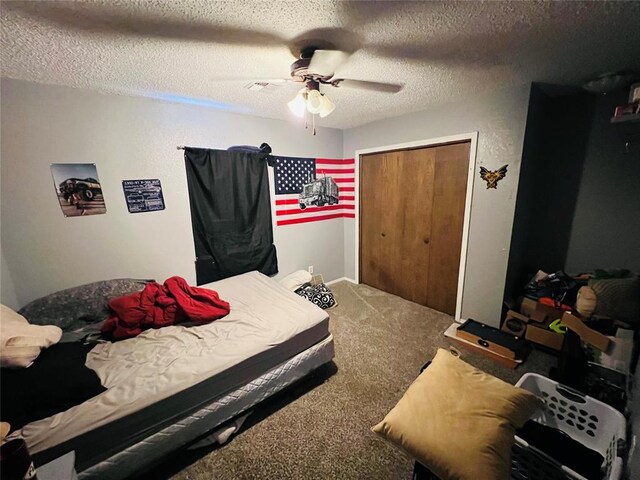 carpeted bedroom with ceiling fan, a textured ceiling, and a closet