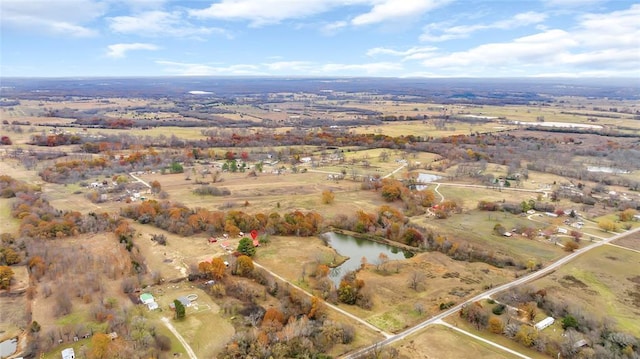 birds eye view of property with a water view and a rural view