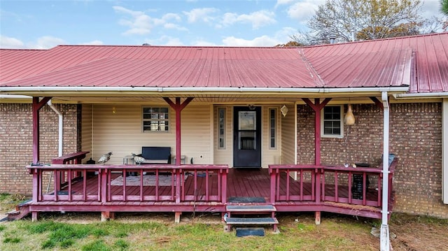 rear view of property featuring a deck