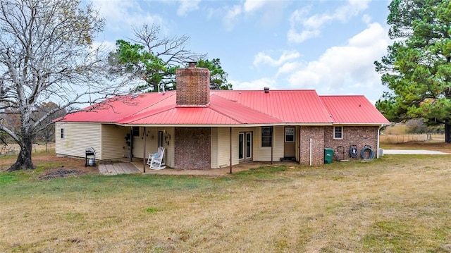 back of house with a yard