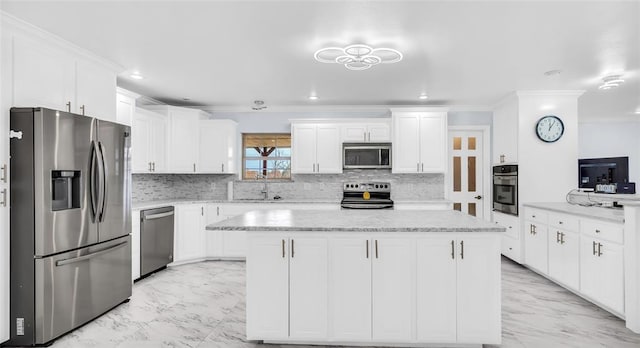 kitchen featuring a center island, white cabinetry, sink, and appliances with stainless steel finishes