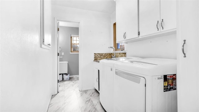 laundry area featuring cabinets and washing machine and clothes dryer