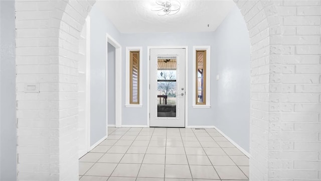 hall with light tile patterned floors and a textured ceiling