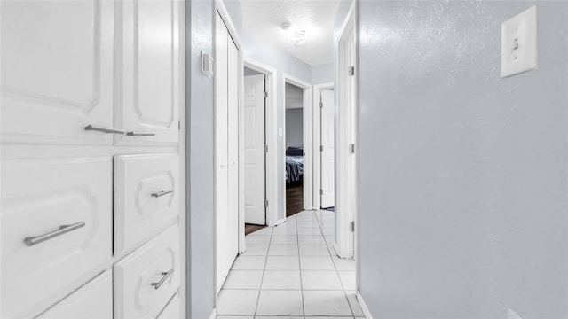 hall featuring light tile patterned flooring