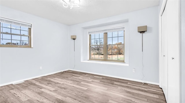 spare room with hardwood / wood-style flooring