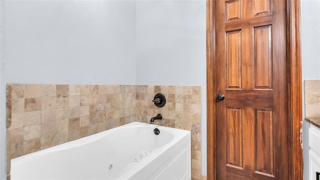 bathroom featuring vanity, a tub, and tile walls