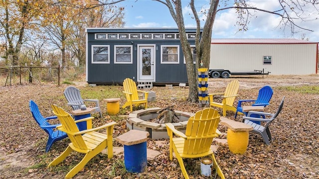 exterior space with an outbuilding and an outdoor fire pit