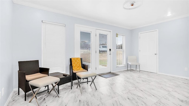 living area with baseboards and crown molding