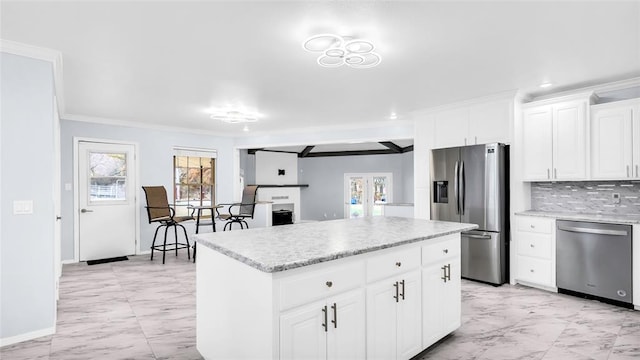 kitchen with marble finish floor, appliances with stainless steel finishes, white cabinets, and a center island