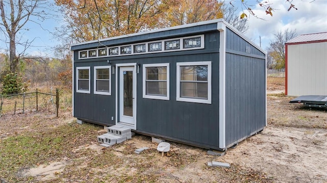 view of outbuilding with an outdoor structure and fence