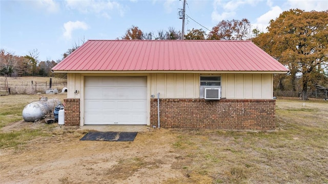 garage featuring driveway and fence