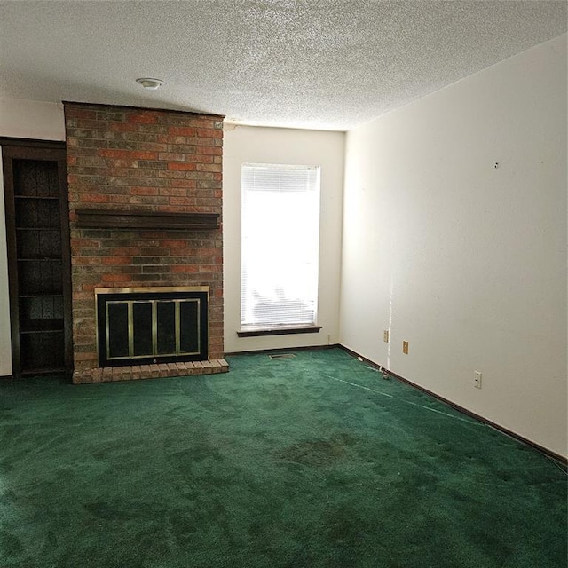 unfurnished living room featuring a textured ceiling, dark carpet, and a fireplace