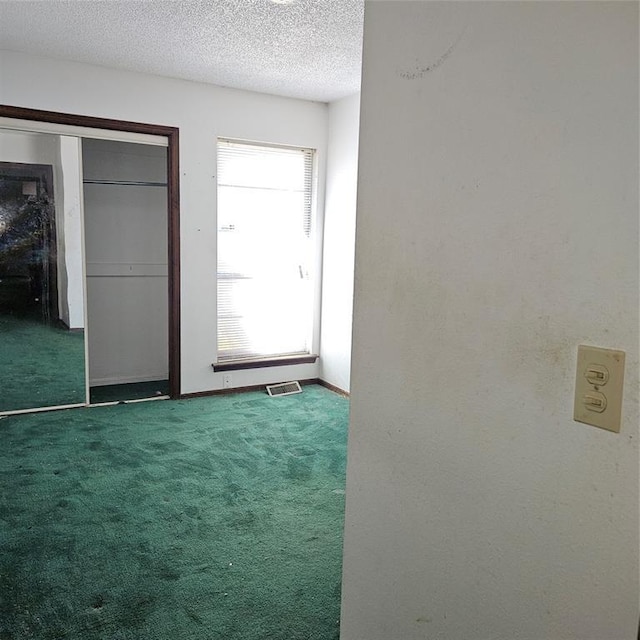 4727 NW 72nd St, Oklahoma City, OK 73132 - unfurnished bedroom featuring carpet floors, a closet, and a textured ceiling