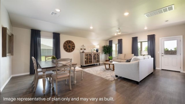 interior space featuring dark wood-style floors, vaulted ceiling, and visible vents