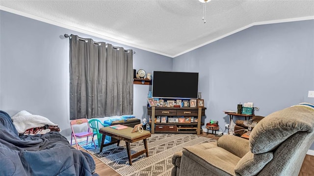 living room with hardwood / wood-style flooring, lofted ceiling, ornamental molding, and a textured ceiling