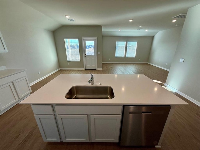 kitchen with dark hardwood / wood-style floors, a center island with sink, stainless steel dishwasher, sink, and white cabinets