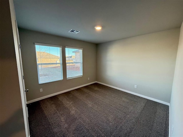 empty room featuring dark carpet