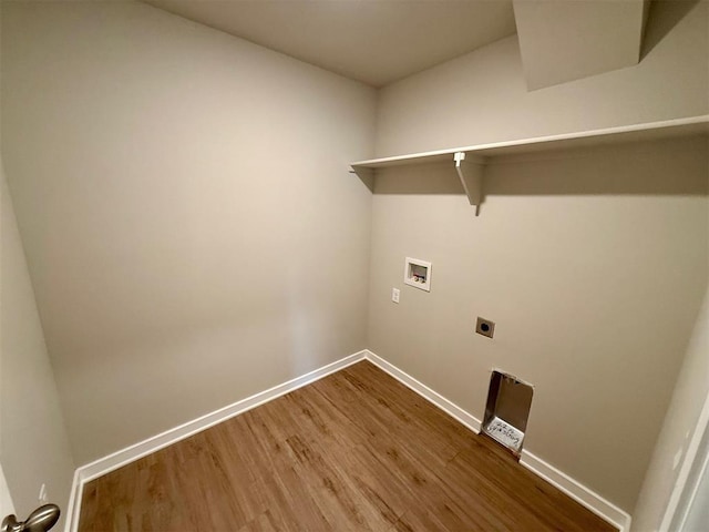 clothes washing area featuring electric dryer hookup, hookup for a washing machine, and hardwood / wood-style flooring