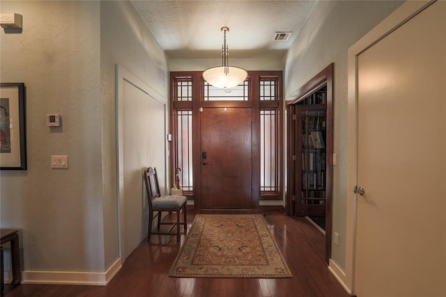 foyer entrance with dark hardwood / wood-style flooring